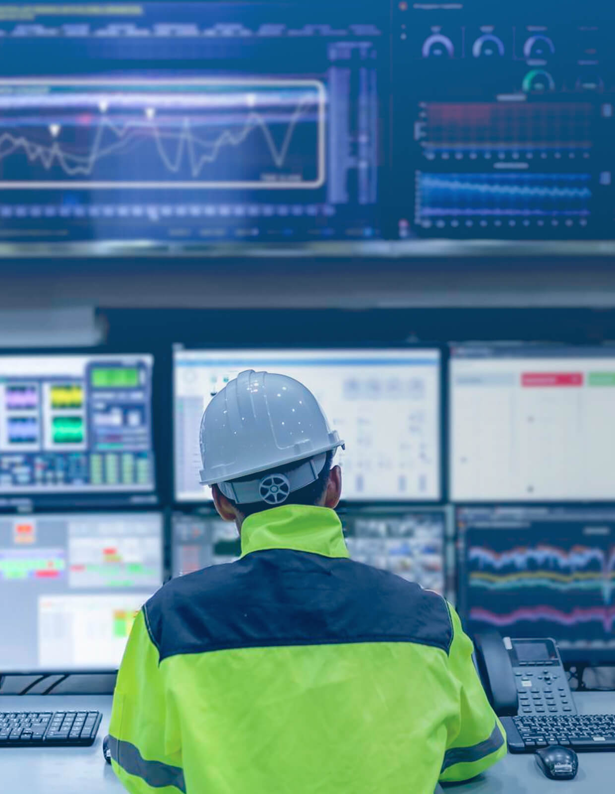 Operator monitoring industrial dashboards